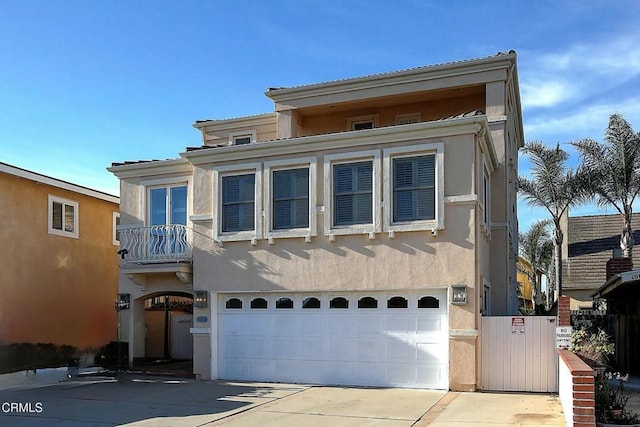 view of front of property with a balcony and a garage