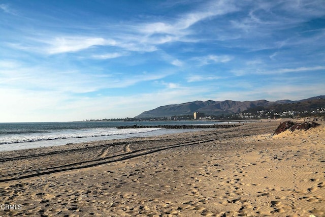 view of water feature featuring a mountain view and a view of the beach