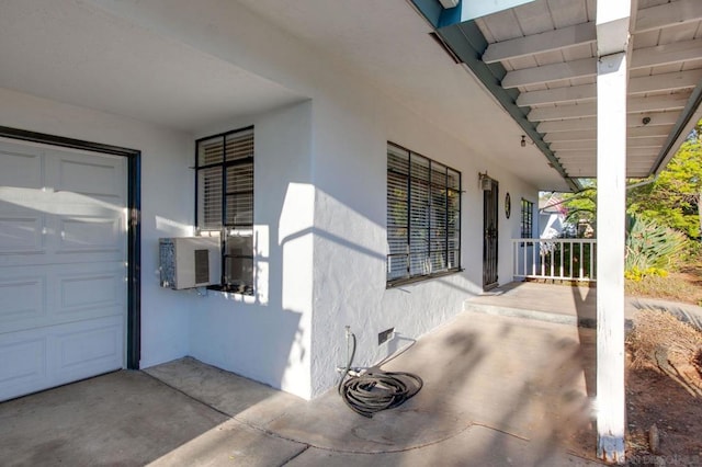 exterior space with cooling unit, covered porch, and a garage