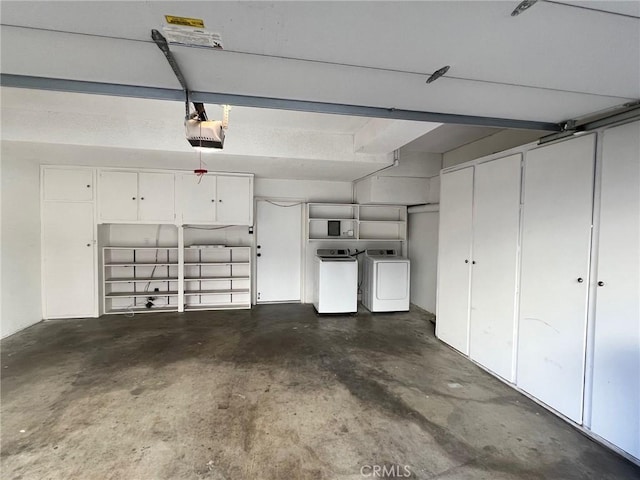 garage with a garage door opener and washer and clothes dryer