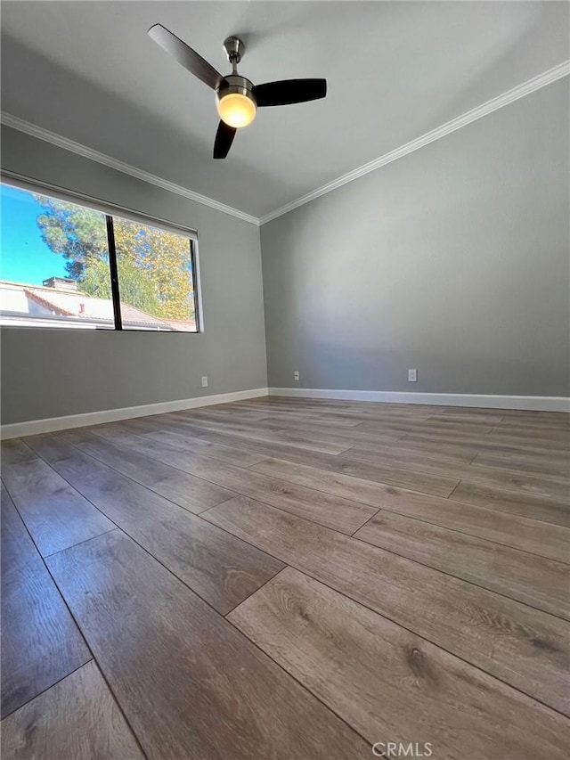 unfurnished room with ceiling fan, crown molding, and wood-type flooring