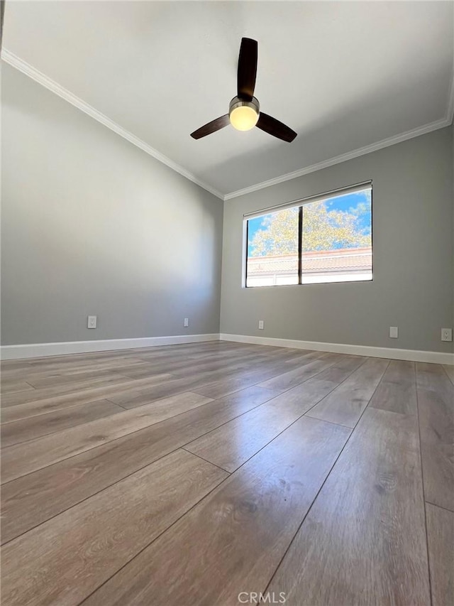 empty room with hardwood / wood-style floors, ceiling fan, and ornamental molding