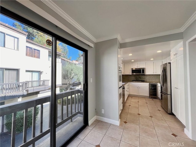 doorway featuring wine cooler, crown molding, and light tile patterned floors