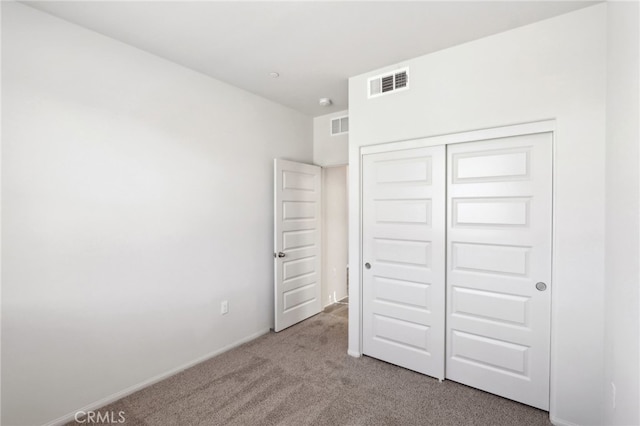 unfurnished bedroom with carpet floors and a closet