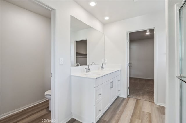 bathroom featuring vanity, hardwood / wood-style floors, and toilet