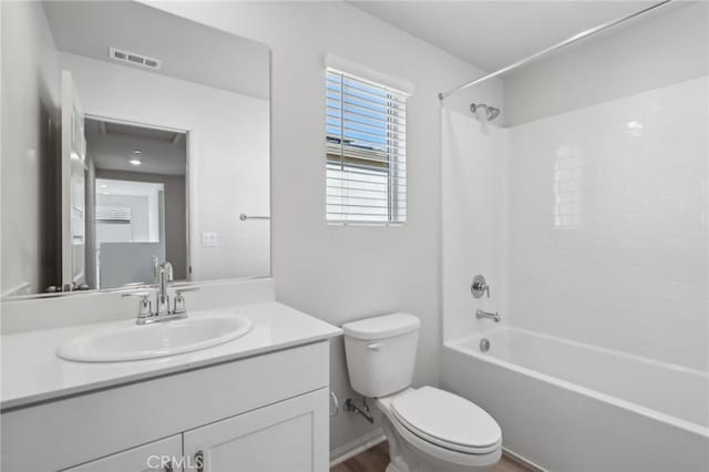 full bathroom featuring vanity, bathtub / shower combination, and toilet