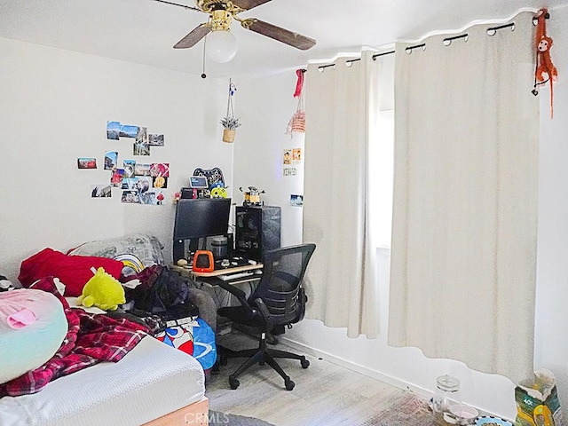 bedroom featuring hardwood / wood-style flooring and ceiling fan