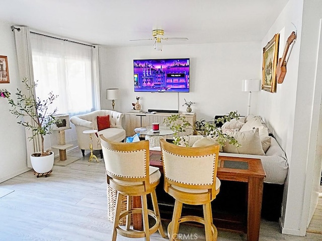 dining room with hardwood / wood-style floors and ceiling fan