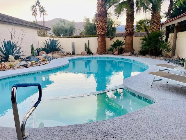 view of swimming pool with a mountain view