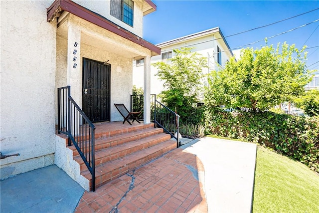 view of exterior entry with a porch