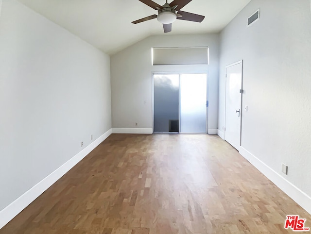 empty room featuring hardwood / wood-style floors, ceiling fan, and lofted ceiling