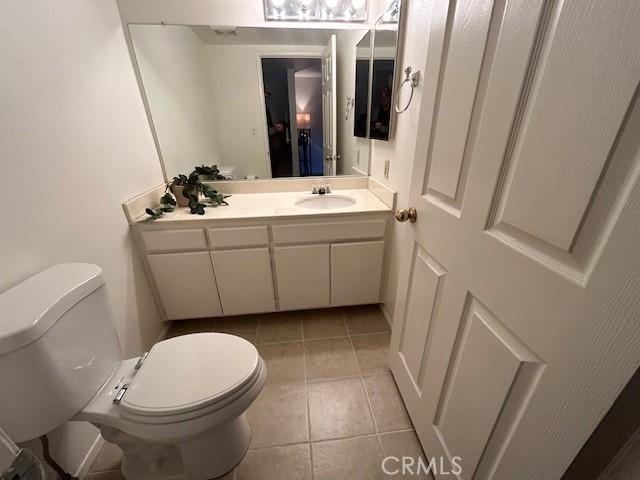 bathroom with tile patterned floors, vanity, and toilet