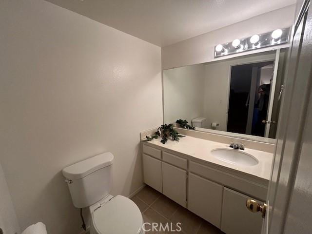 bathroom featuring tile patterned floors, vanity, and toilet