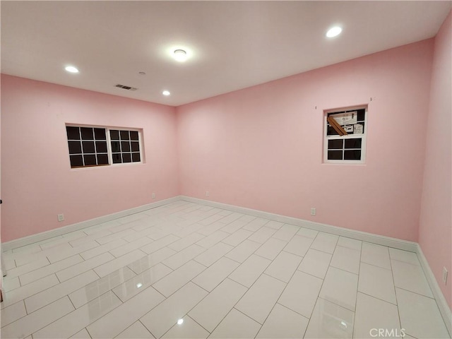 spare room featuring recessed lighting, visible vents, and baseboards