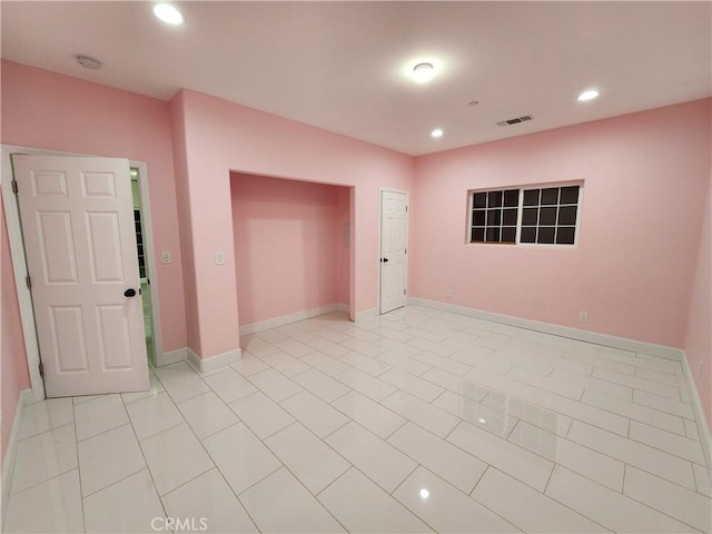 empty room with light tile patterned floors