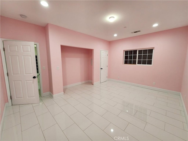 spare room featuring baseboards, light tile patterned flooring, visible vents, and recessed lighting