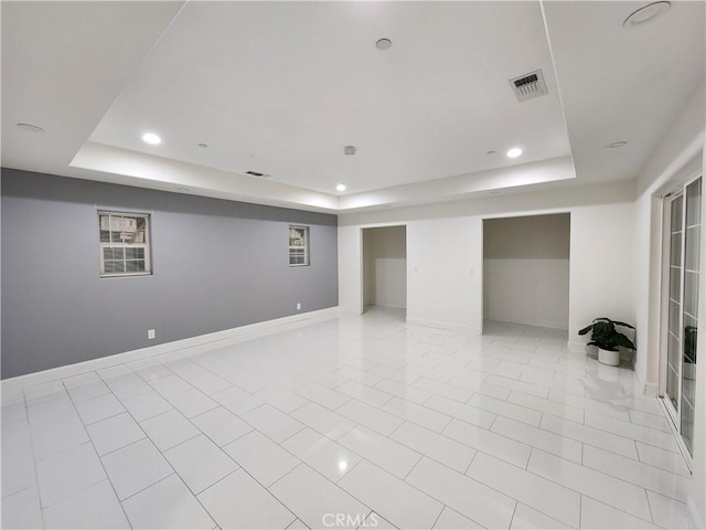 spare room featuring a tray ceiling