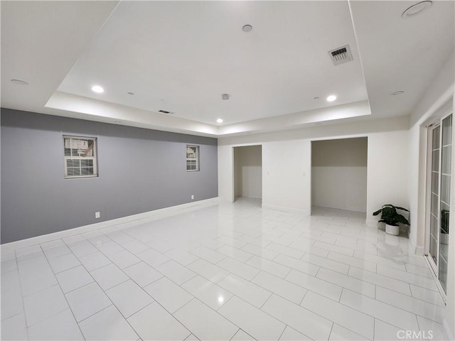 finished basement featuring recessed lighting, visible vents, baseboards, and light tile patterned floors