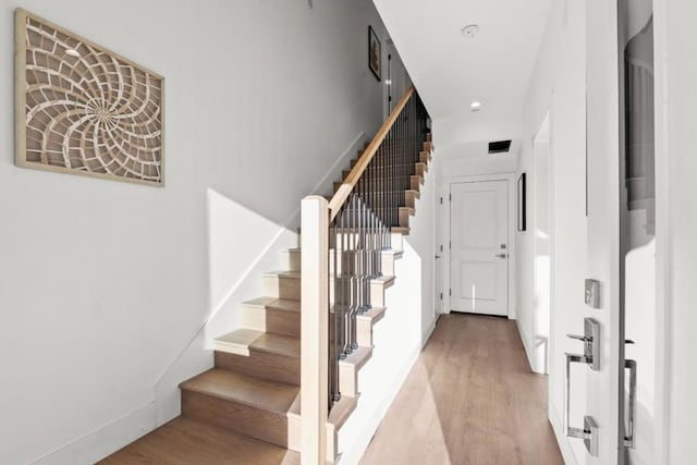 staircase featuring hardwood / wood-style flooring