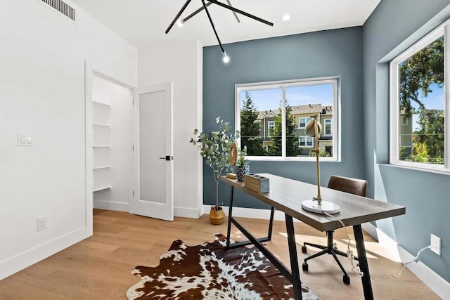 office featuring plenty of natural light and light hardwood / wood-style flooring