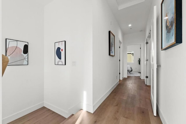 corridor with light hardwood / wood-style flooring