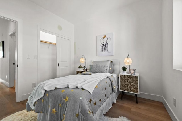 bedroom featuring dark hardwood / wood-style flooring and a closet