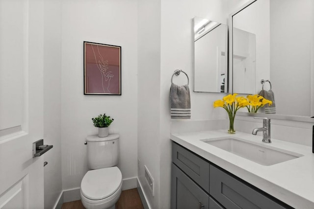 bathroom featuring vanity and toilet