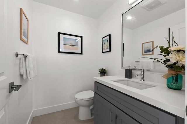 bathroom featuring vanity, tile patterned flooring, and toilet