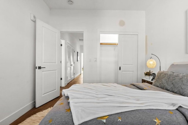 bedroom featuring dark hardwood / wood-style flooring and a closet