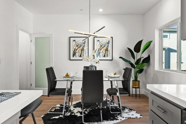 dining area with an inviting chandelier and light hardwood / wood-style floors