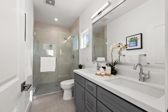 bathroom with vanity, tile patterned flooring, toilet, and walk in shower