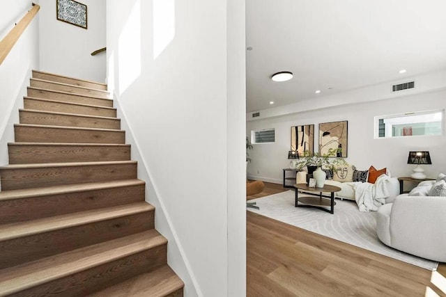 staircase featuring wood-type flooring