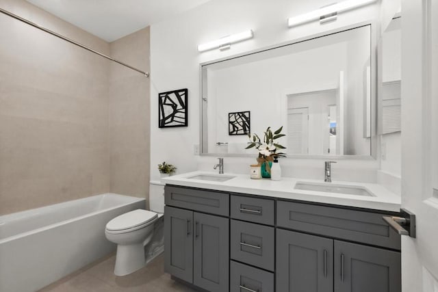 full bathroom with tiled shower / bath, vanity, toilet, and tile patterned floors