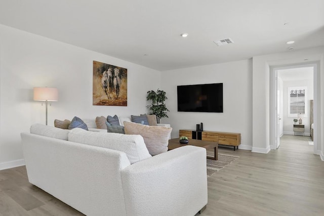 living room with light hardwood / wood-style flooring