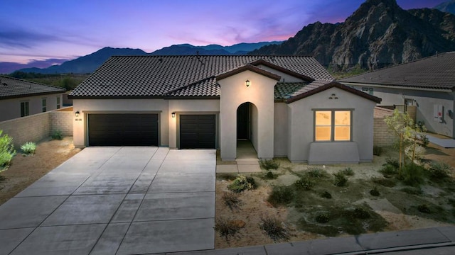 mediterranean / spanish home featuring a garage and a mountain view