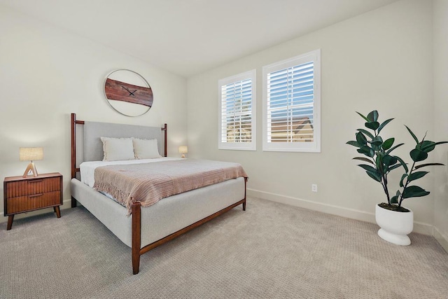 bedroom featuring light carpet