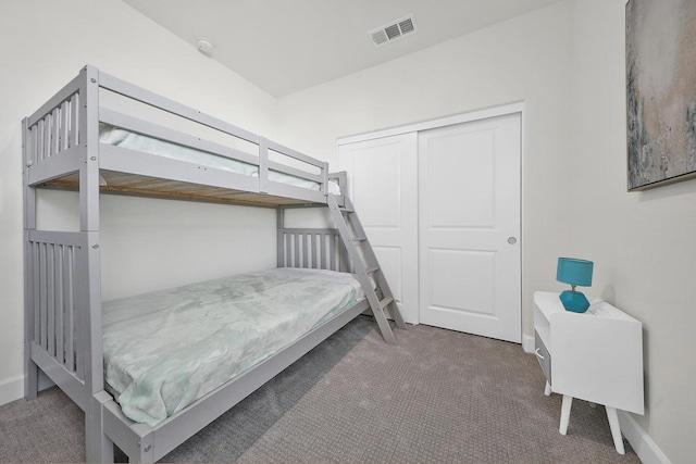 bedroom featuring a closet and dark colored carpet