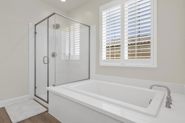 bathroom with wood-type flooring and plus walk in shower