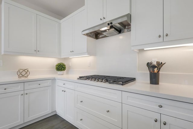 kitchen featuring stainless steel gas stovetop, white cabinetry, and dark hardwood / wood-style flooring