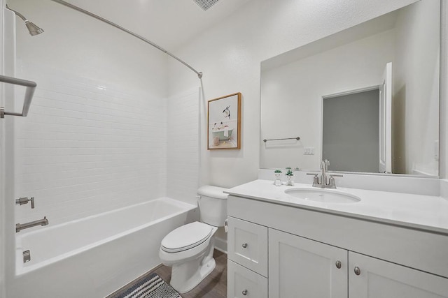 full bathroom featuring vanity, wood-type flooring, toilet, and tiled shower / bath