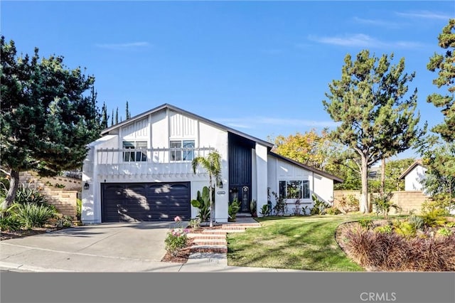 view of front of property with a garage and a front lawn