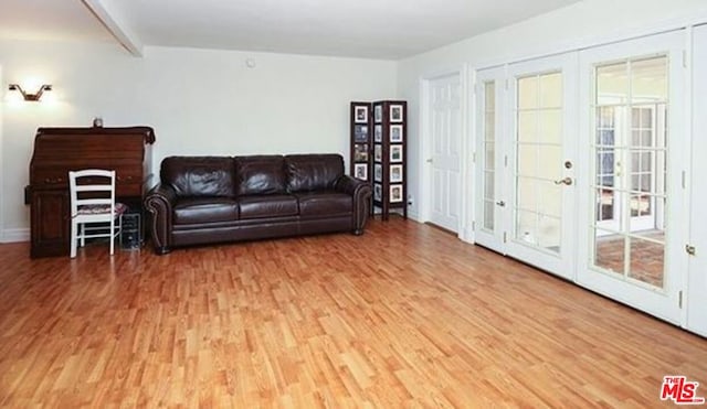 living room with beamed ceiling, french doors, hardwood / wood-style flooring, and plenty of natural light