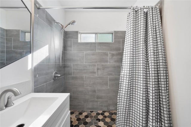 bathroom featuring vanity and curtained shower