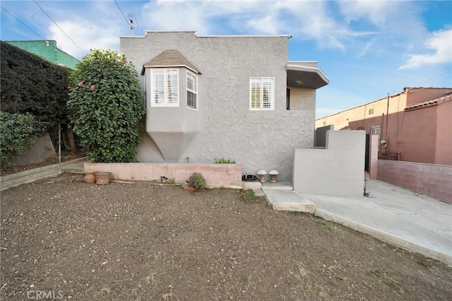 view of side of home featuring a patio