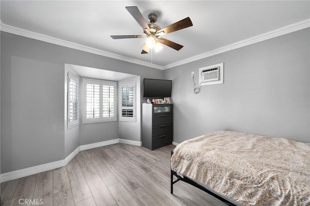 bedroom featuring ceiling fan, light hardwood / wood-style floors, crown molding, and a wall mounted AC