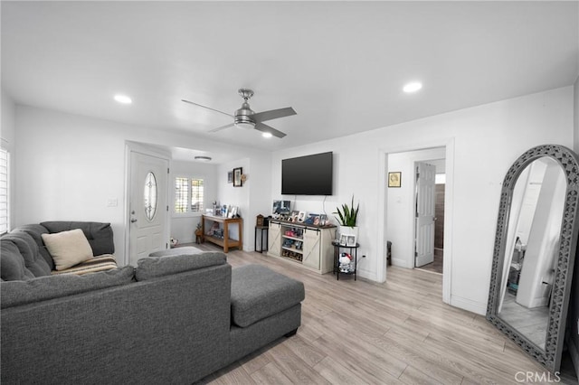 living room featuring ceiling fan and light wood-type flooring