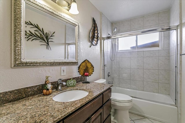 full bathroom with tile patterned flooring, vanity, toilet, and bath / shower combo with glass door