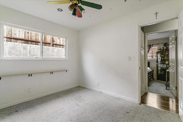 spare room with hardwood / wood-style flooring, ceiling fan, and a healthy amount of sunlight