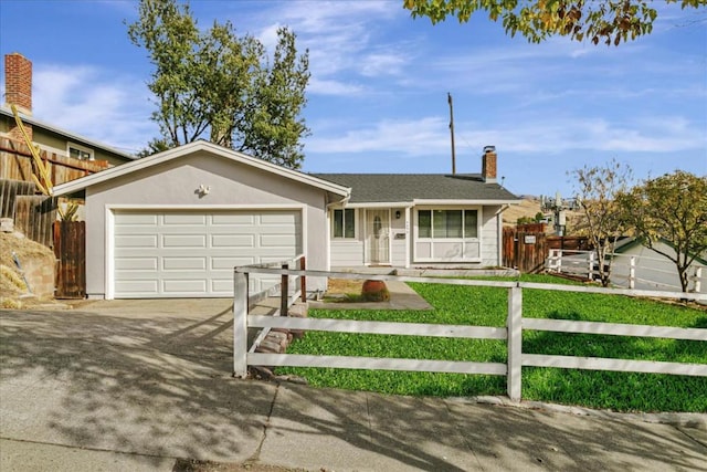 ranch-style home with a front lawn and a garage