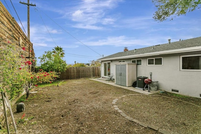 view of yard featuring central air condition unit and a shed